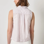 Woman wearing a sleeveless striped shirt against a plain background