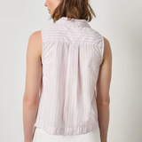 Woman wearing a sleeveless striped shirt against a plain background