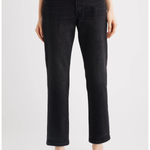 A model wearing black cropped straight-leg jeans with a gray top and black pointed-toe heels, shown from the waist down against a light gray studio background.