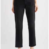 A model wearing black cropped straight-leg jeans with a gray top and black pointed-toe heels, shown from the waist down against a light gray studio background.
