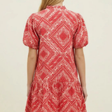 Model wearing a red bandana print V-neck mini dress with short sleeves and a relaxed silhouette.