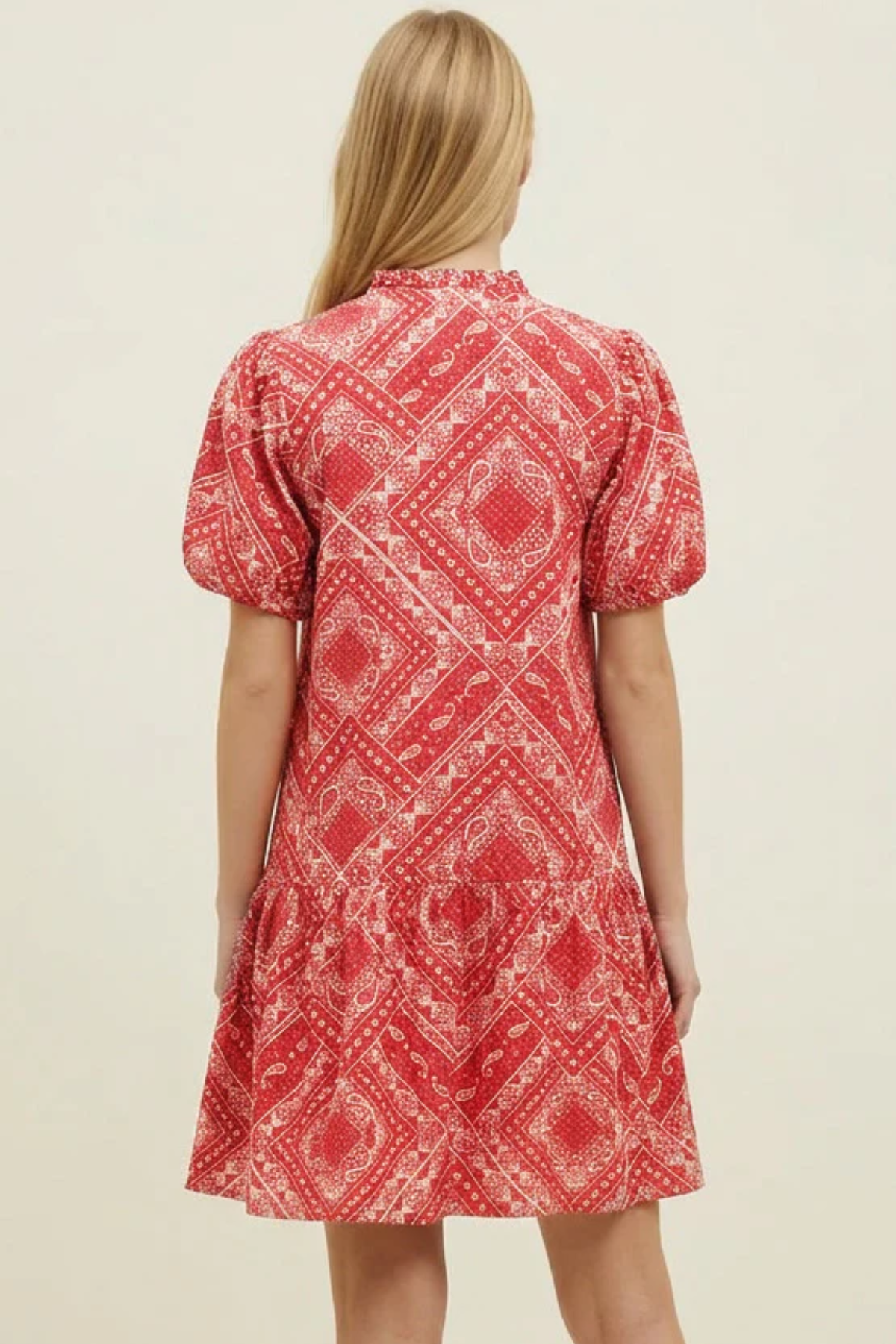 Model wearing a red bandana print V-neck mini dress with short sleeves and a relaxed silhouette.