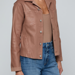 Model wearing a light-wash slim-fit denim jacket with raw hem detailing and a button-front design.