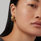 Gold hoop earrings with a smooth, polished finish.