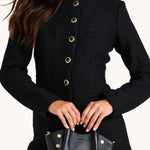 Black Hammitt Paul Mini crossbody bag worn with an evening outfit.