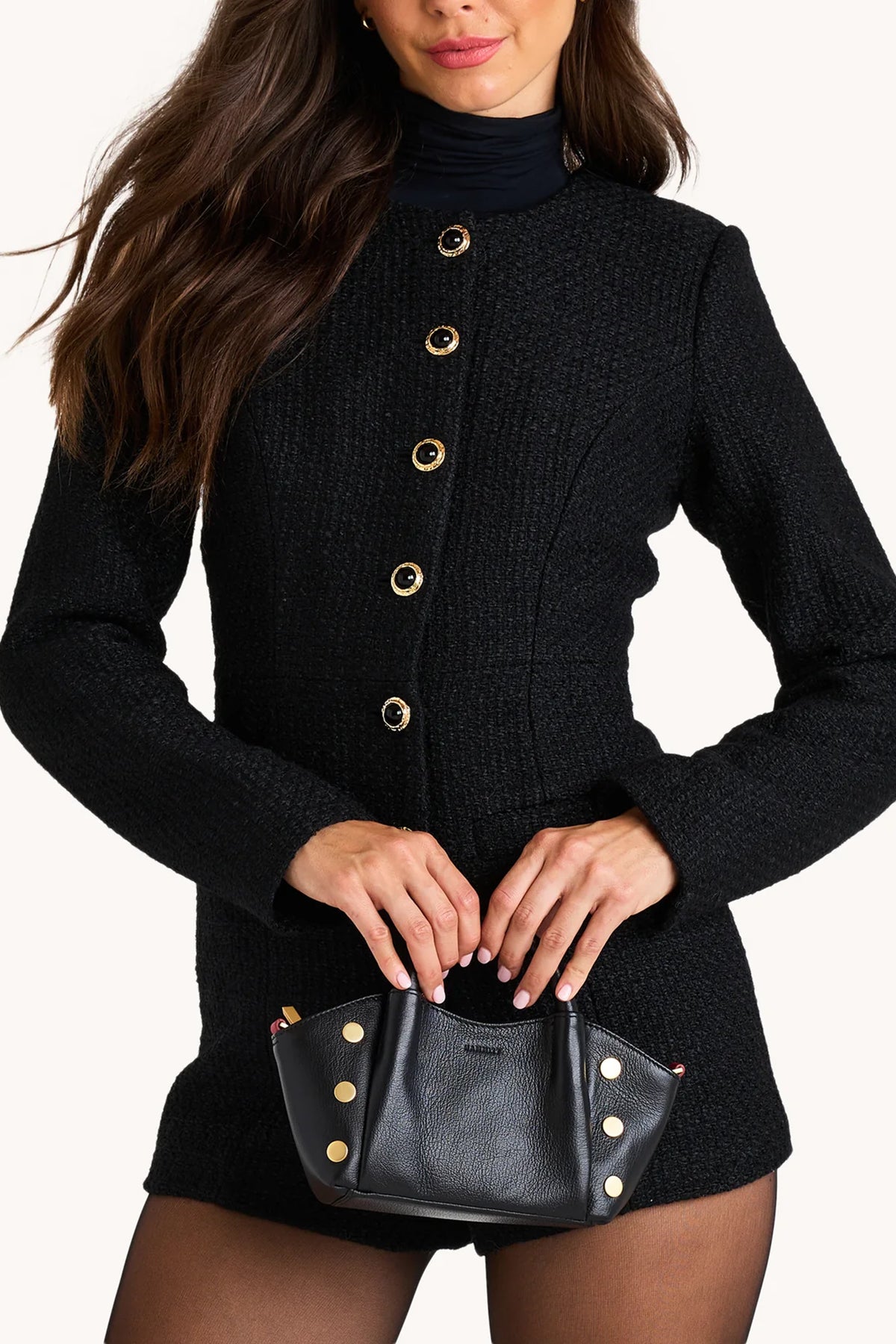 Black Hammitt Paul Mini crossbody bag worn with an evening outfit.