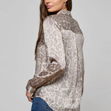 Long-sleeve blouse with a smooth, polished finish.