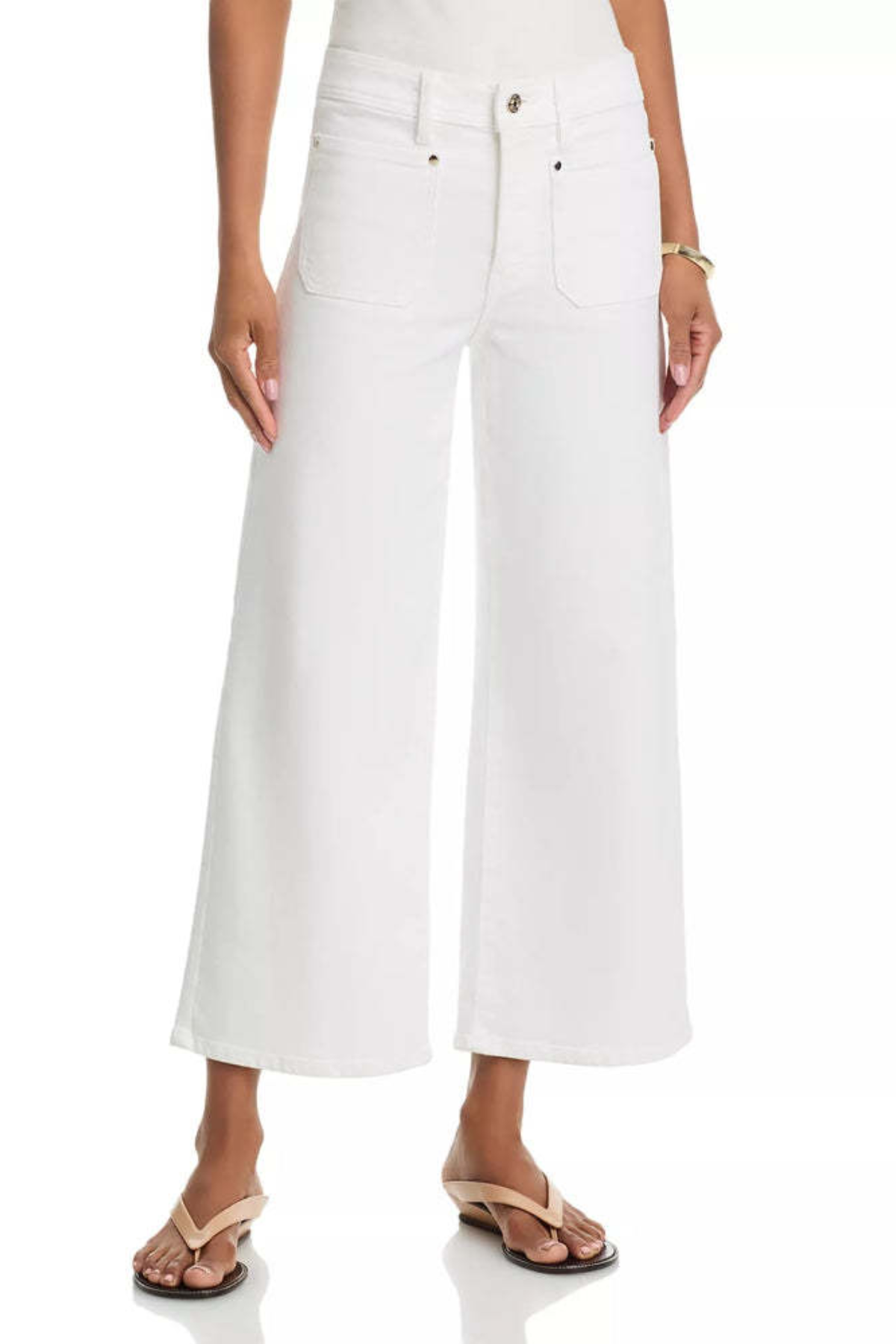 White cropped wide-leg denim jeans worn by a model, paired with beige thong sandals against a clean white background.