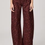 Women's printed full-length pants featuring an etched tulip pattern in rich garnet tones.