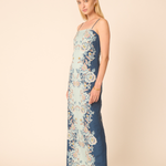 Woman wearing a floral dress with a beige background