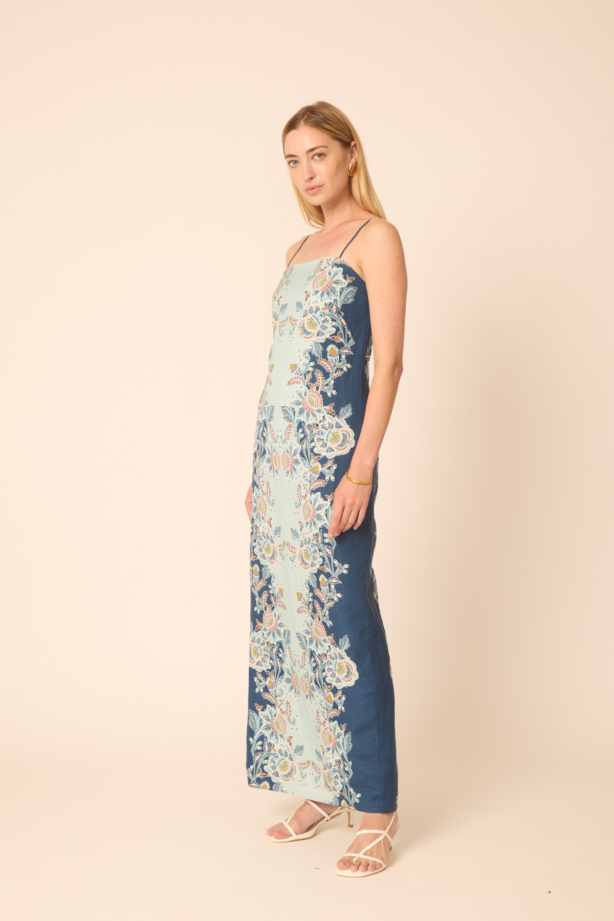 Woman wearing a floral dress with a beige background