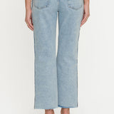 Light blue jeans worn by a person on a white background