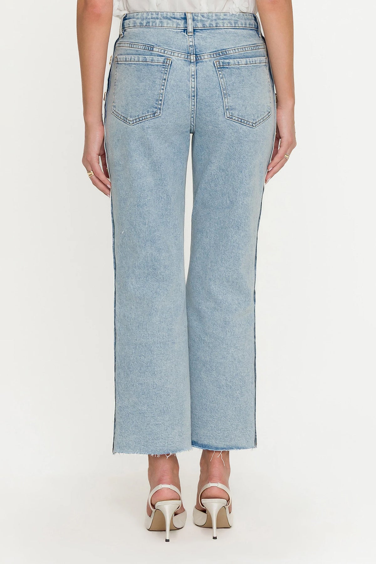 Light blue jeans worn by a person on a white background