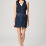 Woman wearing a denim dress on a white background