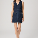 Woman wearing a denim dress on a white background
