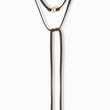 Brown bolo tie necklace with gold accents on a white background