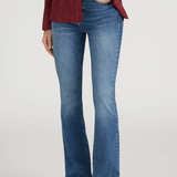 Person wearing blue jeans and a red blazer on a white background