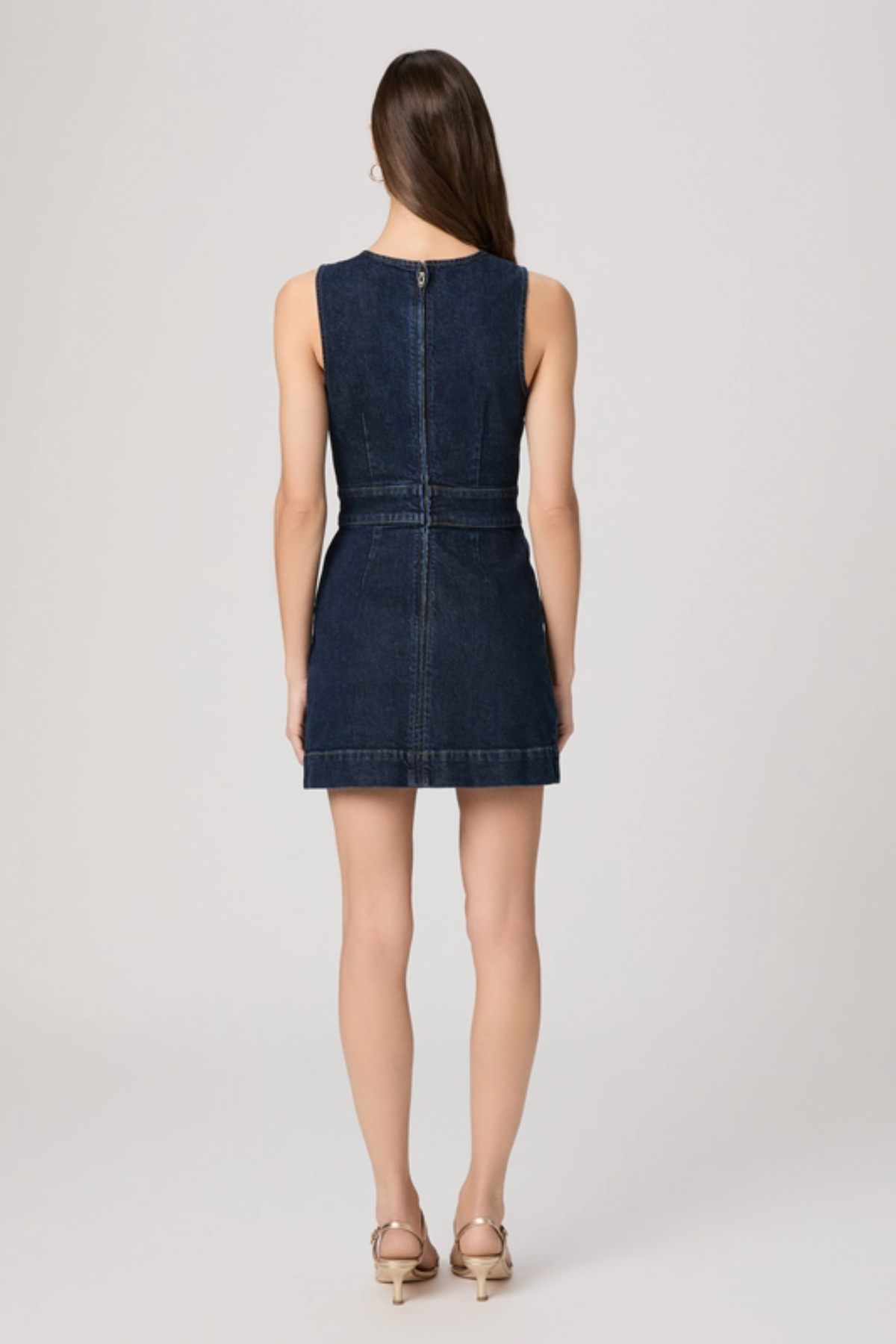 Woman wearing a blue denim dress on a white background