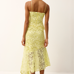Woman wearing a yellow lace set on a white background