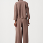Person wearing a brown suit on a white background