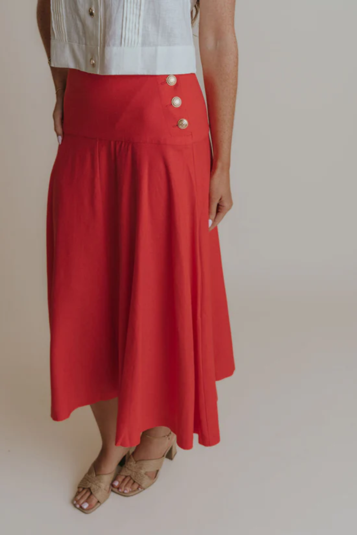 woman in red skirt on tan background 