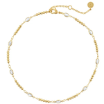 A delicate gold chain necklace with small oval clear stones spaced along the chain, displayed on a clean white background.