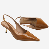 A pair of glossy brown patent leather slingback pumps with pointed toes and slim gold-tone heels, displayed on a light gray background.