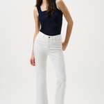 Woman wearing a black sleeveless top and white pants on a white background