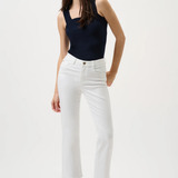 Woman wearing a black sleeveless top and white pants on a white background