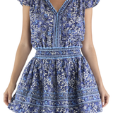 Woman wearing a blue floral dress on a white background