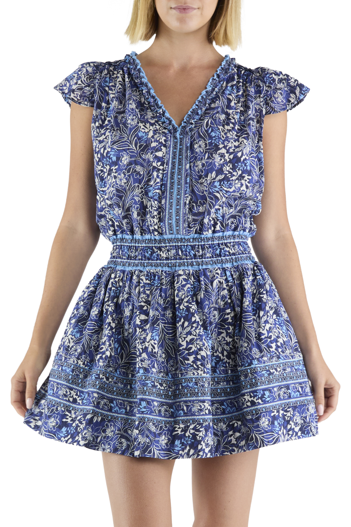 Woman wearing a blue floral dress on a white background
