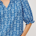 close up on woman in blue printed blouse on white background 