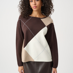 Woman wearing a brown, beige, and white patterned sweater on a white background