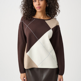 Woman wearing a brown, beige, and white patterned sweater on a white background