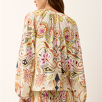 woman in printed long sleeve top from the back on white background 