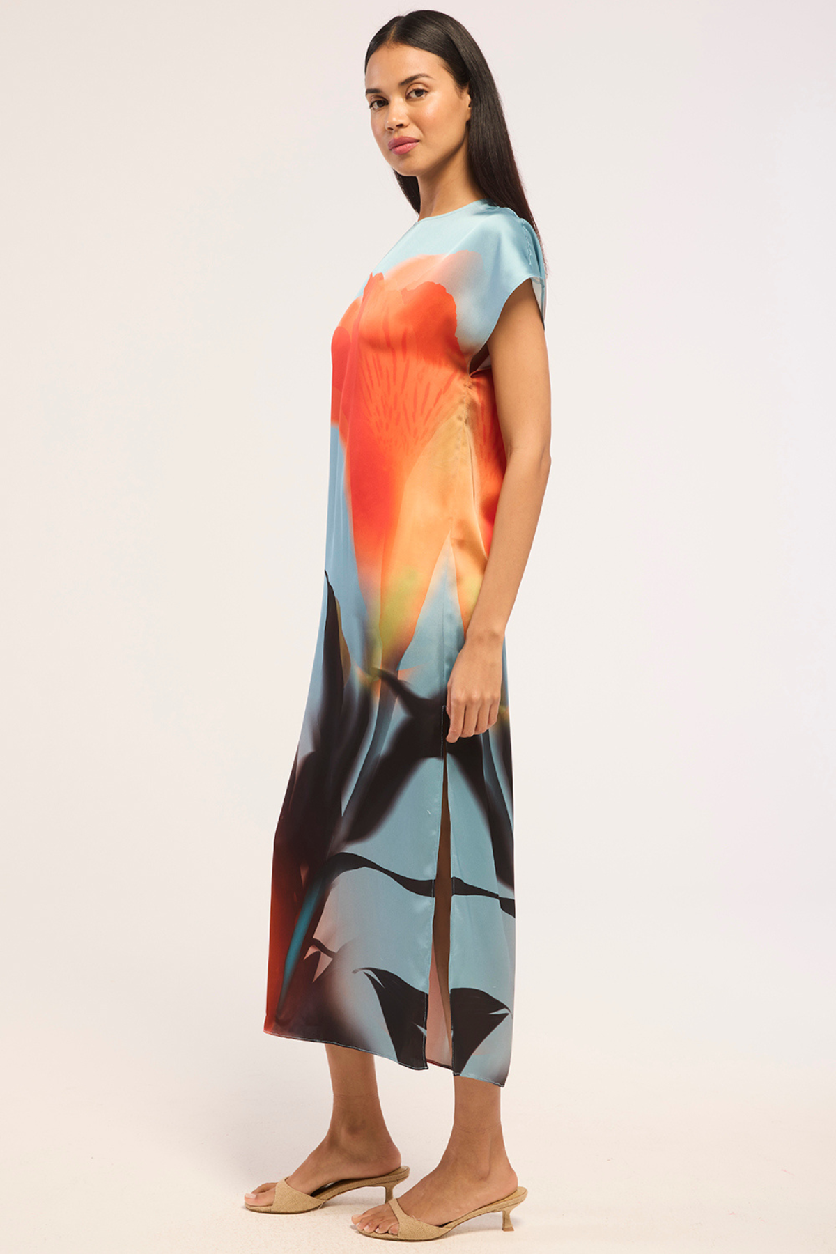 Model wearing a colorful printed sleeveless midi dress.