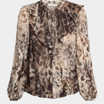 A long-sleeve blouse with a snakeskin print in shades of brown, beige, and black, featuring a ruffled round neckline and gathered sleeves, shown against a light gray background.