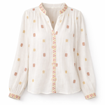White blouse with orange patterns on a white background