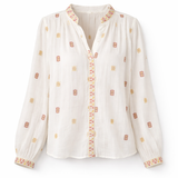 White blouse with orange patterns on a white background