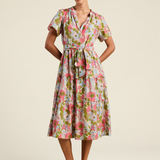 Woman wearing a floral dress on a beige background