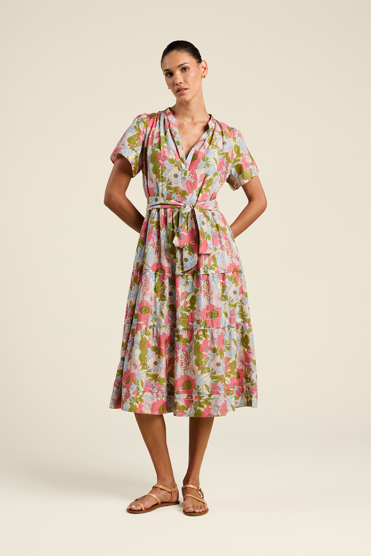 Woman wearing a floral dress on a beige background