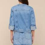 Denim jacket and skirt set on a beige background