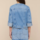 Denim jacket and skirt set on a beige background