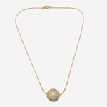 A delicate gold chain necklace featuring a textured, spherical pavé pendant, displayed against a solid light gray background.