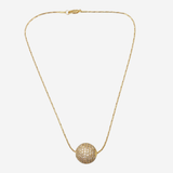 A delicate gold chain necklace featuring a textured, spherical pavé pendant, displayed against a solid light gray background.