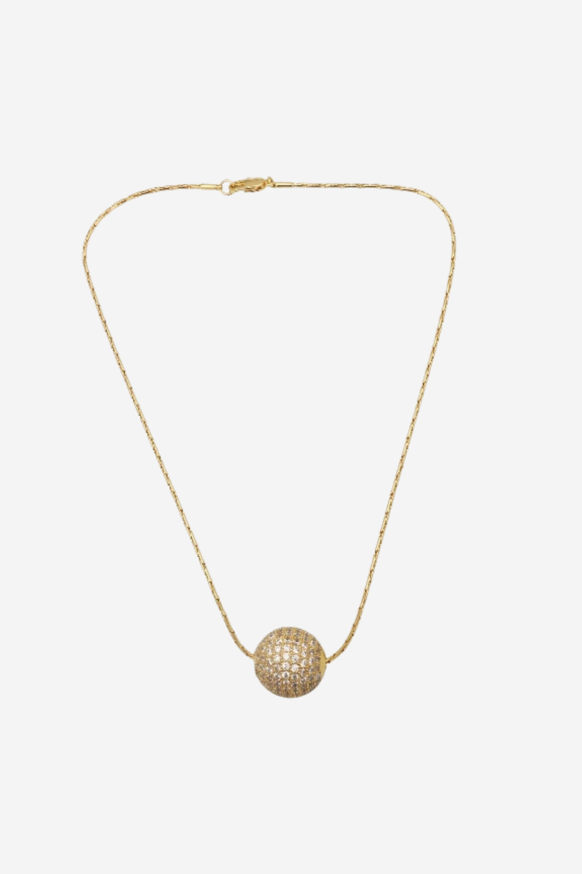 A delicate gold chain necklace featuring a textured, spherical pavé pendant, displayed against a solid light gray background.