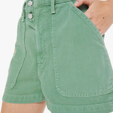 Green shorts worn by a person on a white background