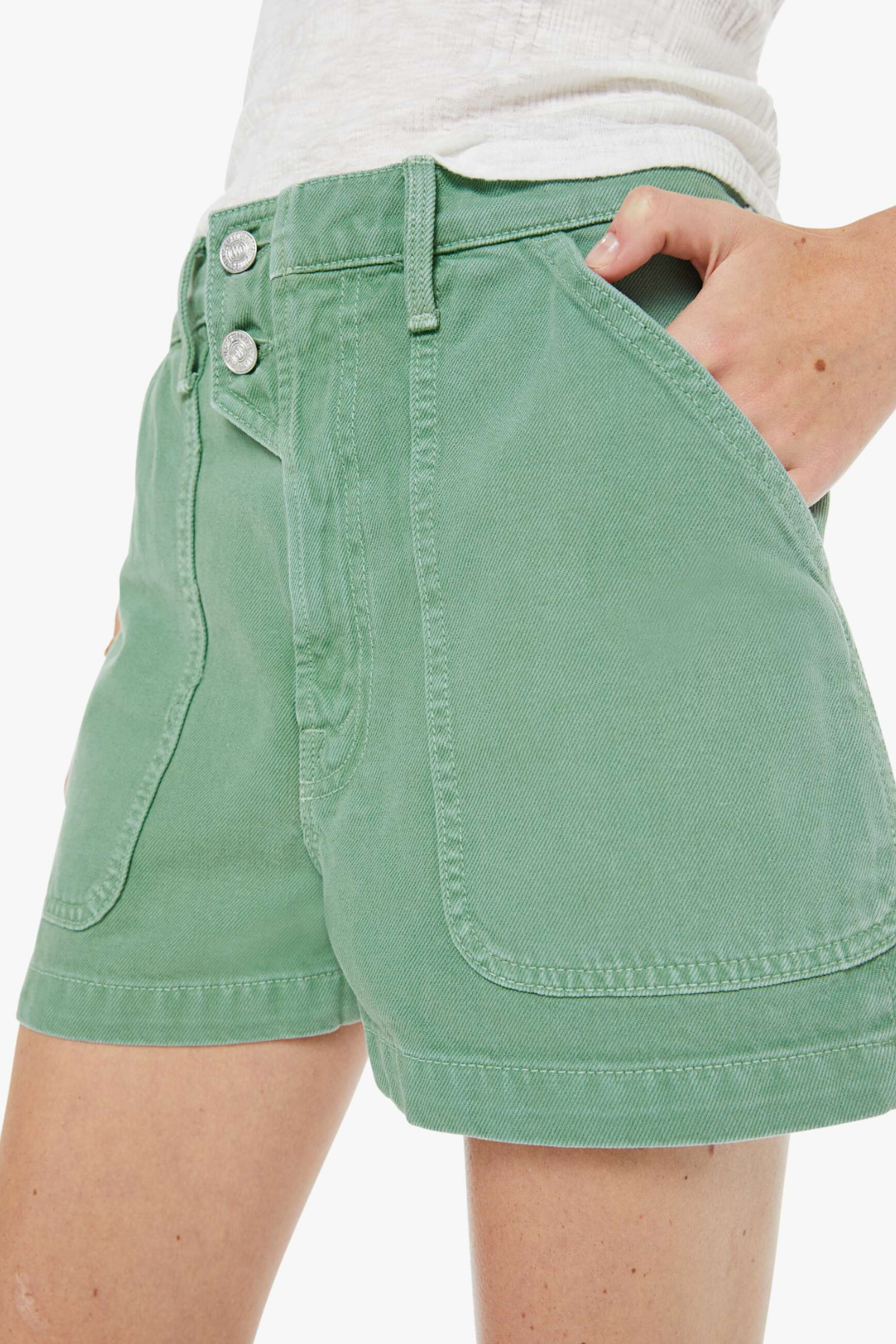 Green shorts worn by a person on a white background