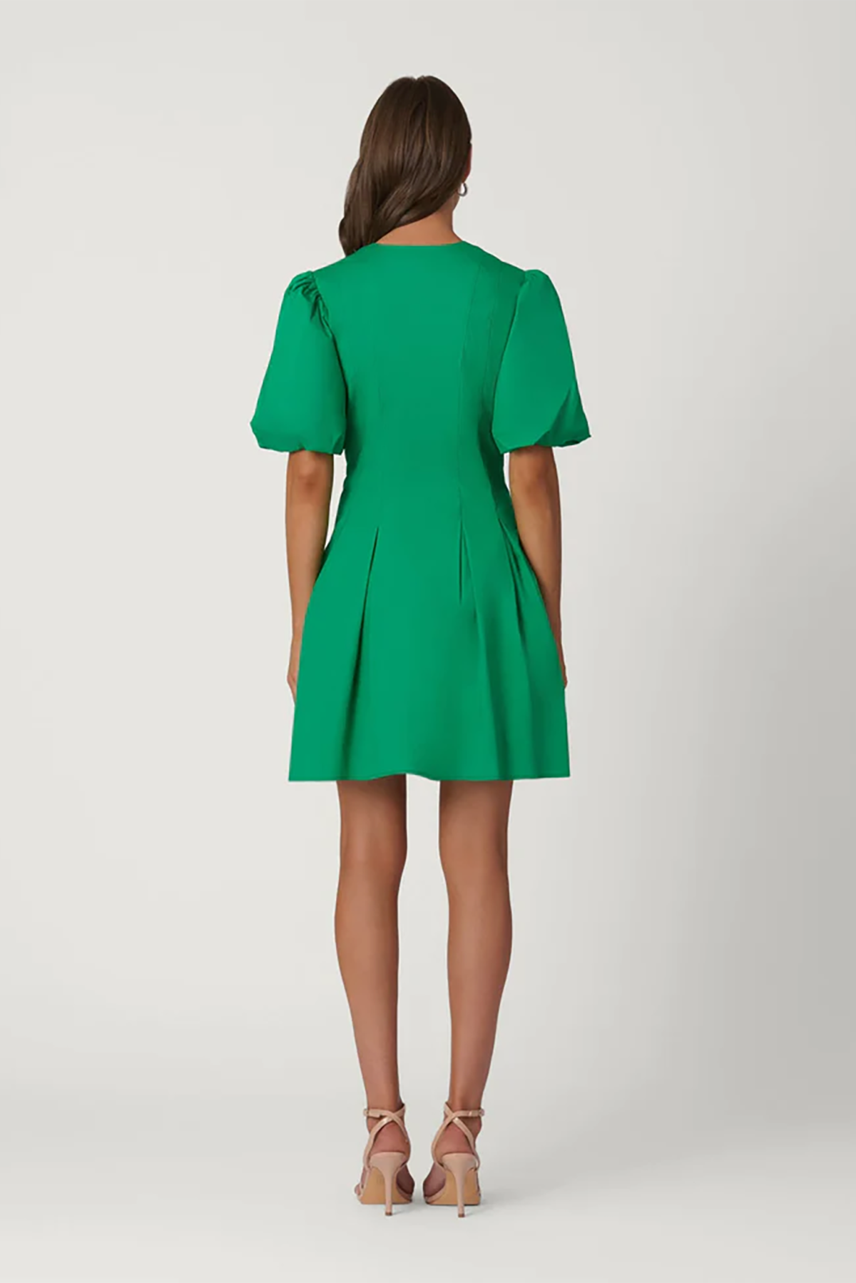 Green dress worn by a model on a white background