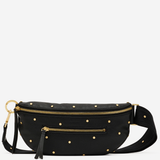 A black faux-leather belt bag with gold-tone hardware, featuring a pattern of small gold studs, a top zipper, a front zip pocket with a tassel, and a detachable shoulder strap, shown against a plain light gray background.